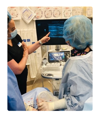 AVA-Doctor and nurses performing vascular procedure and looking at monitor